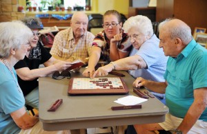 Dolores Beebe, left, Marilyn Kline, John Rogers, temporary center coordinator Denise Dorans, Jo Pompeo, and Anthony Morello, play scrabble at the 56th Street Senior Center in Bayonne, Wednesday, July 30, 2008. -- REENA ROSE SIBAYAN / THE JERSEY JOURNAL