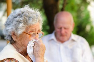 Elderly woman has flu in the nature